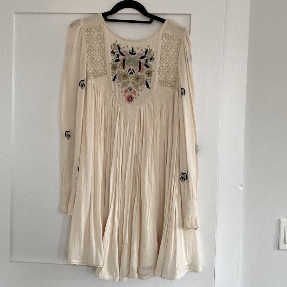 Cream colored mini dress with embroidery from free people.